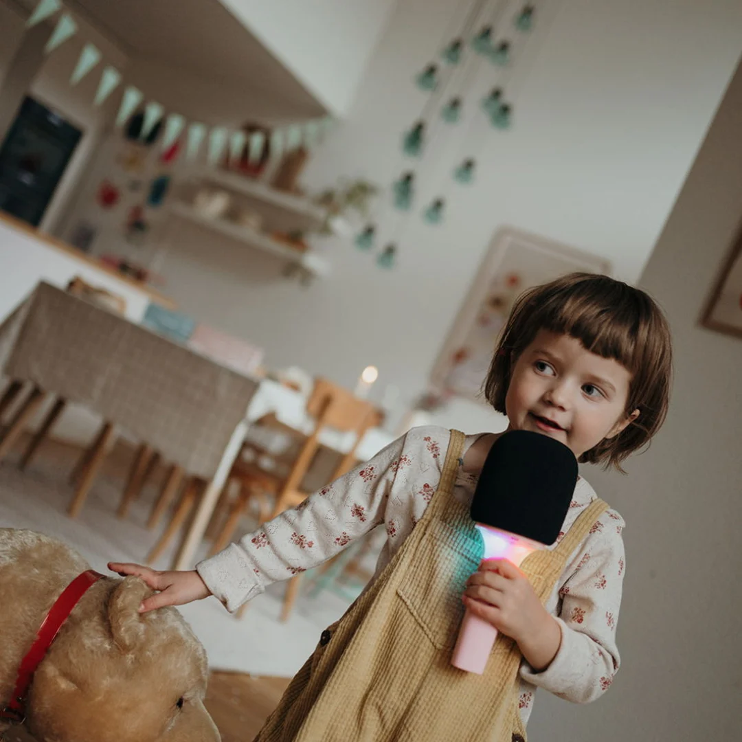 Μικρόφωνο Karaoke Επαναφορτιζόμενο Με Φως & Bluetooth Ροζ με το οποίο παίζει ένα παιδάκι